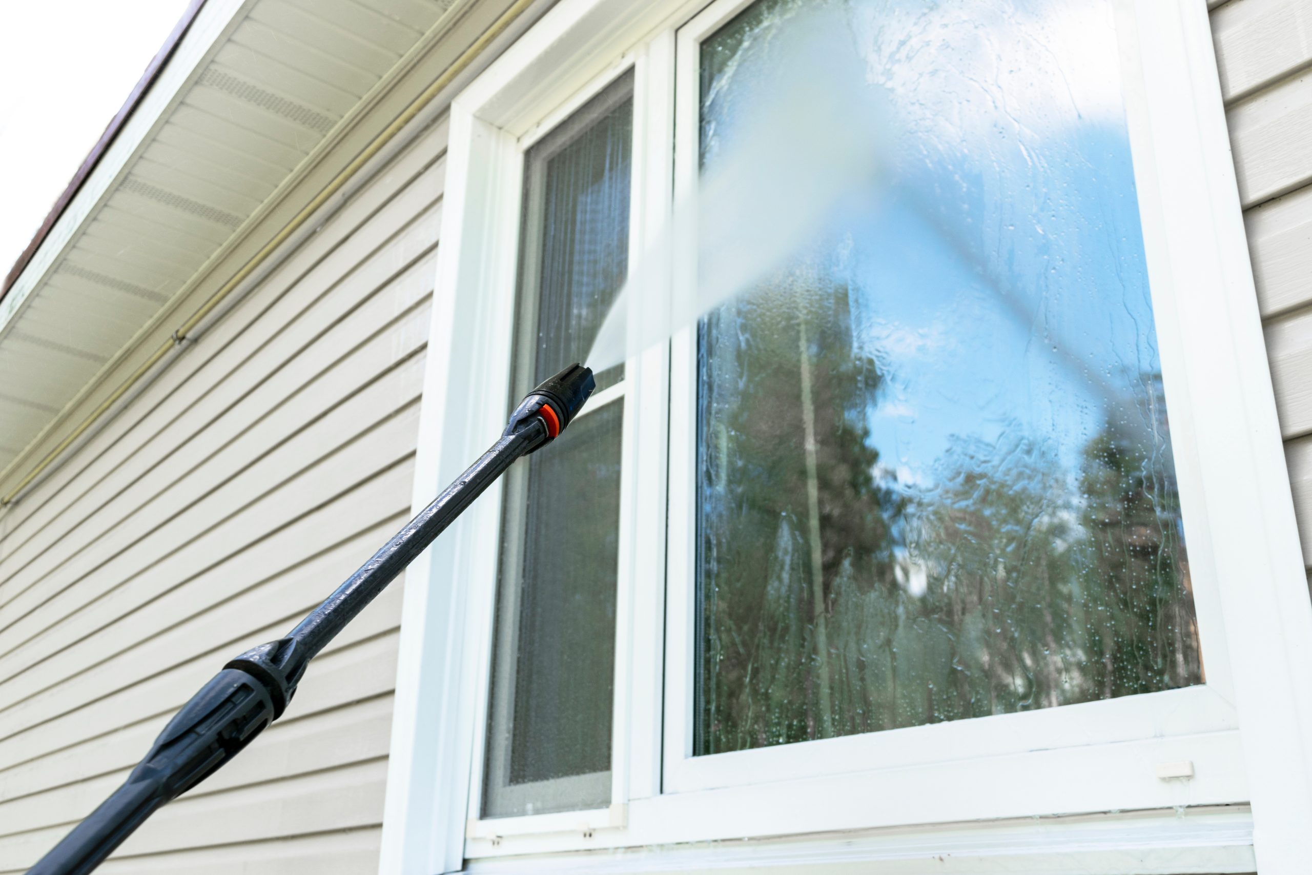 cleaning a house by pressure washing